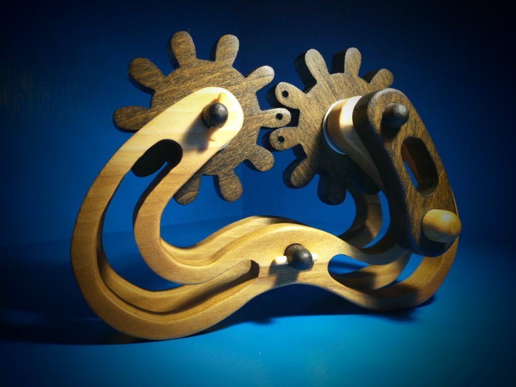 Close-up of intricate brass clock gears against a blue background.
