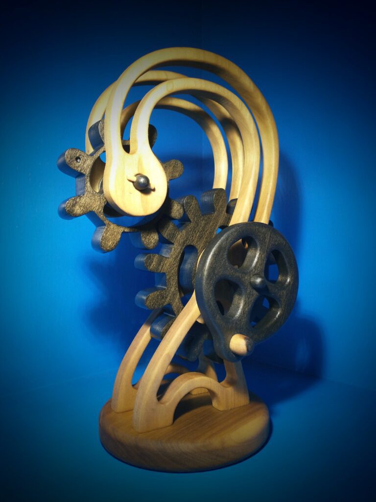 Elegant wooden sculpture with intricate curves and mechanical gears.