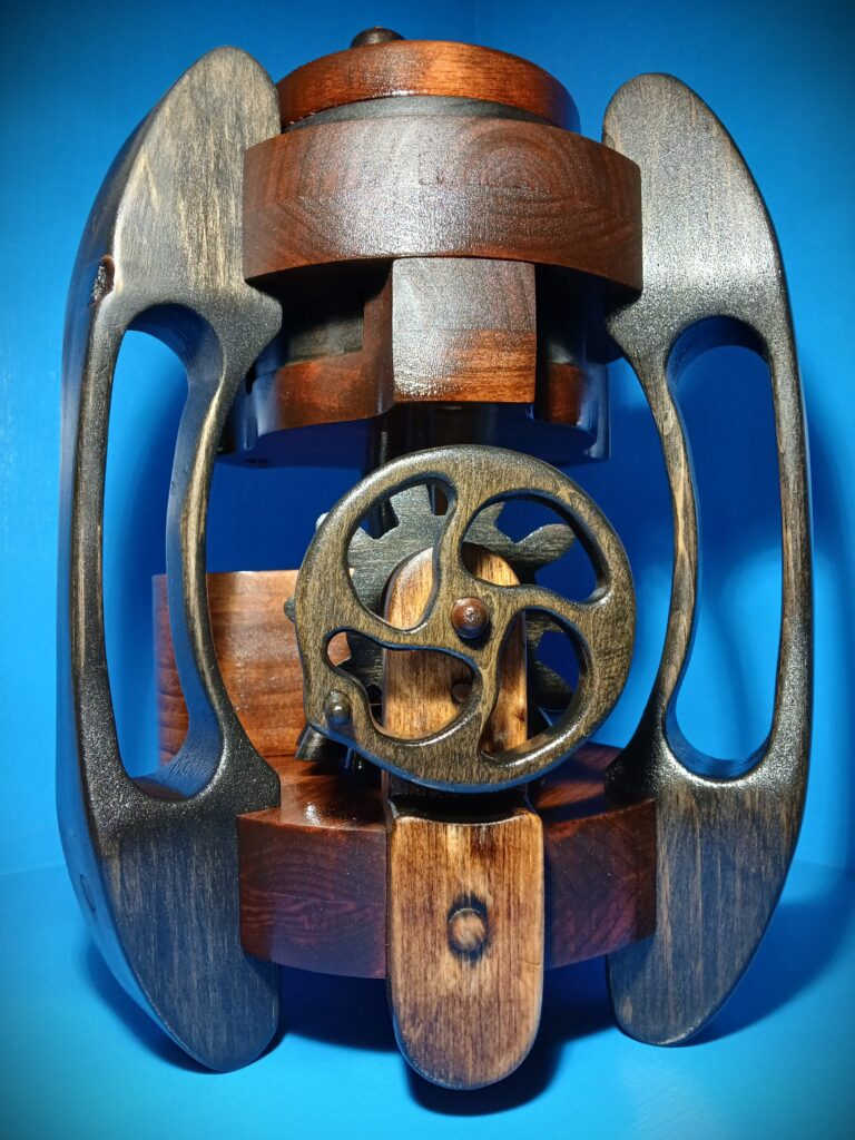 Close-up of a metal and wooden mechanical component with gears.