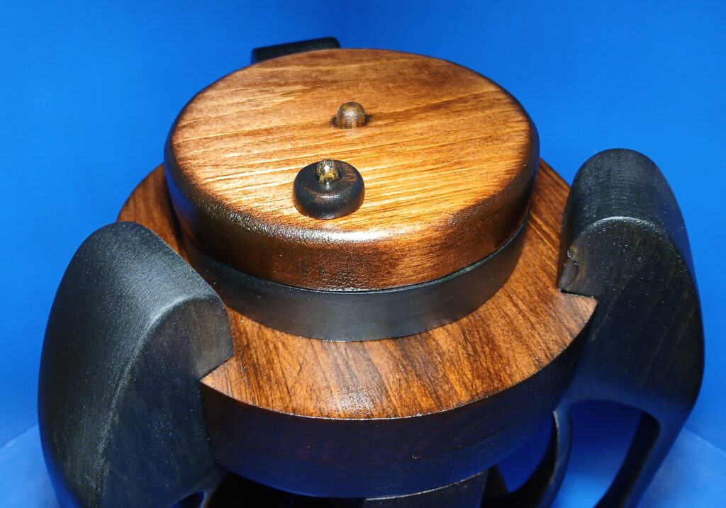 Close-up of a wooden mechanical component with metal details.