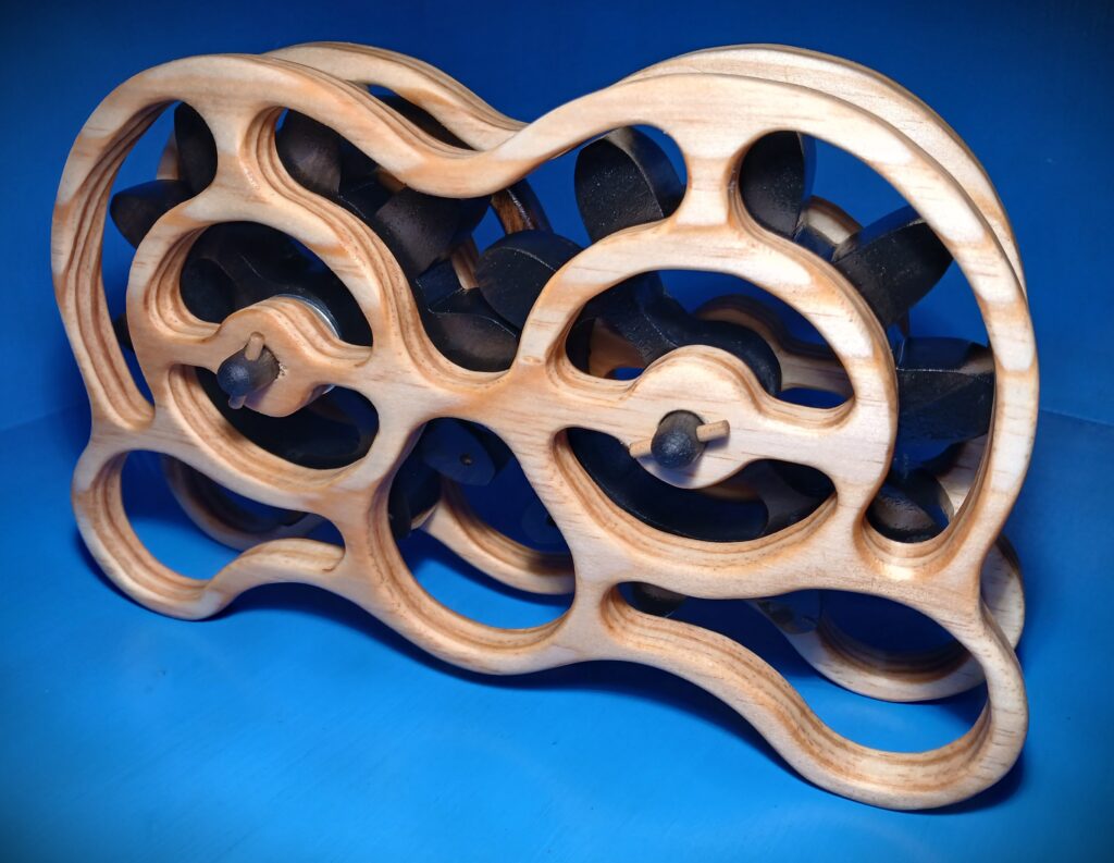 Intricately carved wooden sculpture with flowing, interconnected loops on a blue background.
