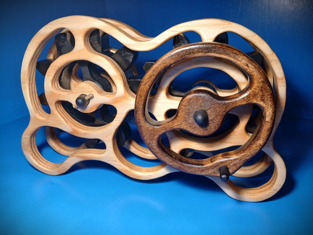 Intricately carved wooden object with flowing, curved shapes against a blue background.